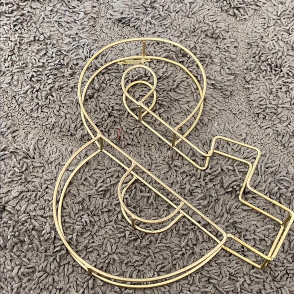 Gold ampersand wall hanging. Metal